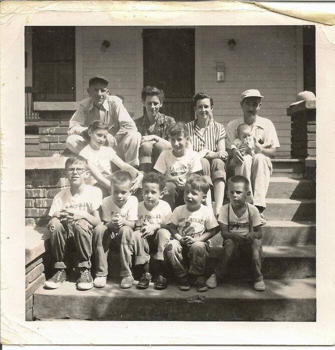 The Mooney and Ore families on the front steps of the Mooney home on Haase Street